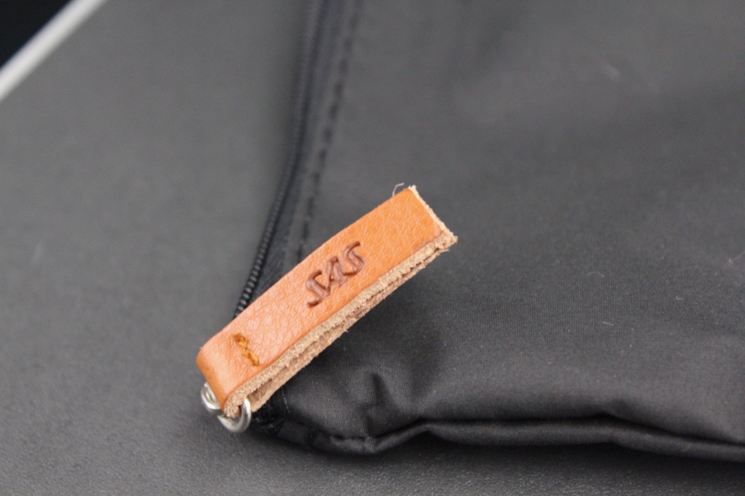 a leather tag on a black bag