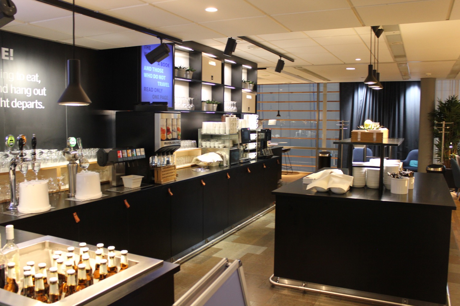a coffee shop with black cabinets and black counter tops