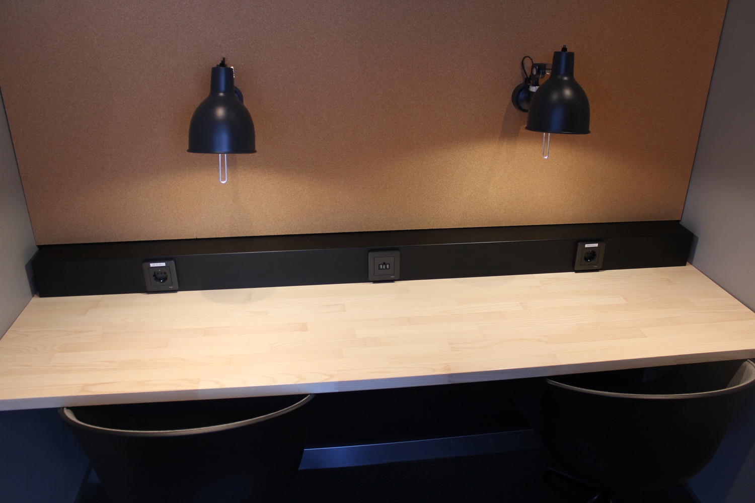 a desk with two black lamps