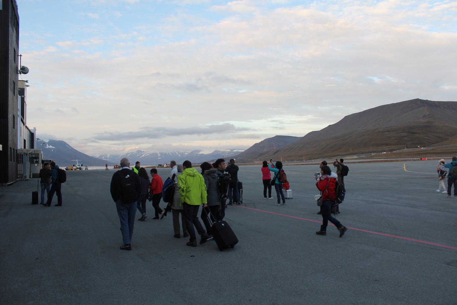 a group of people standing on a tarmac