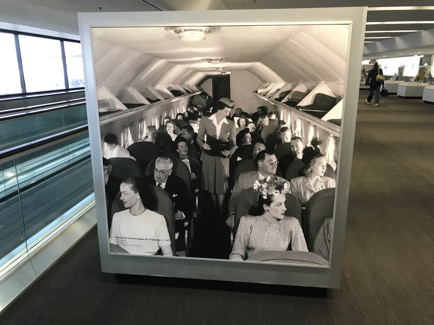 a large picture of people sitting in an airplane