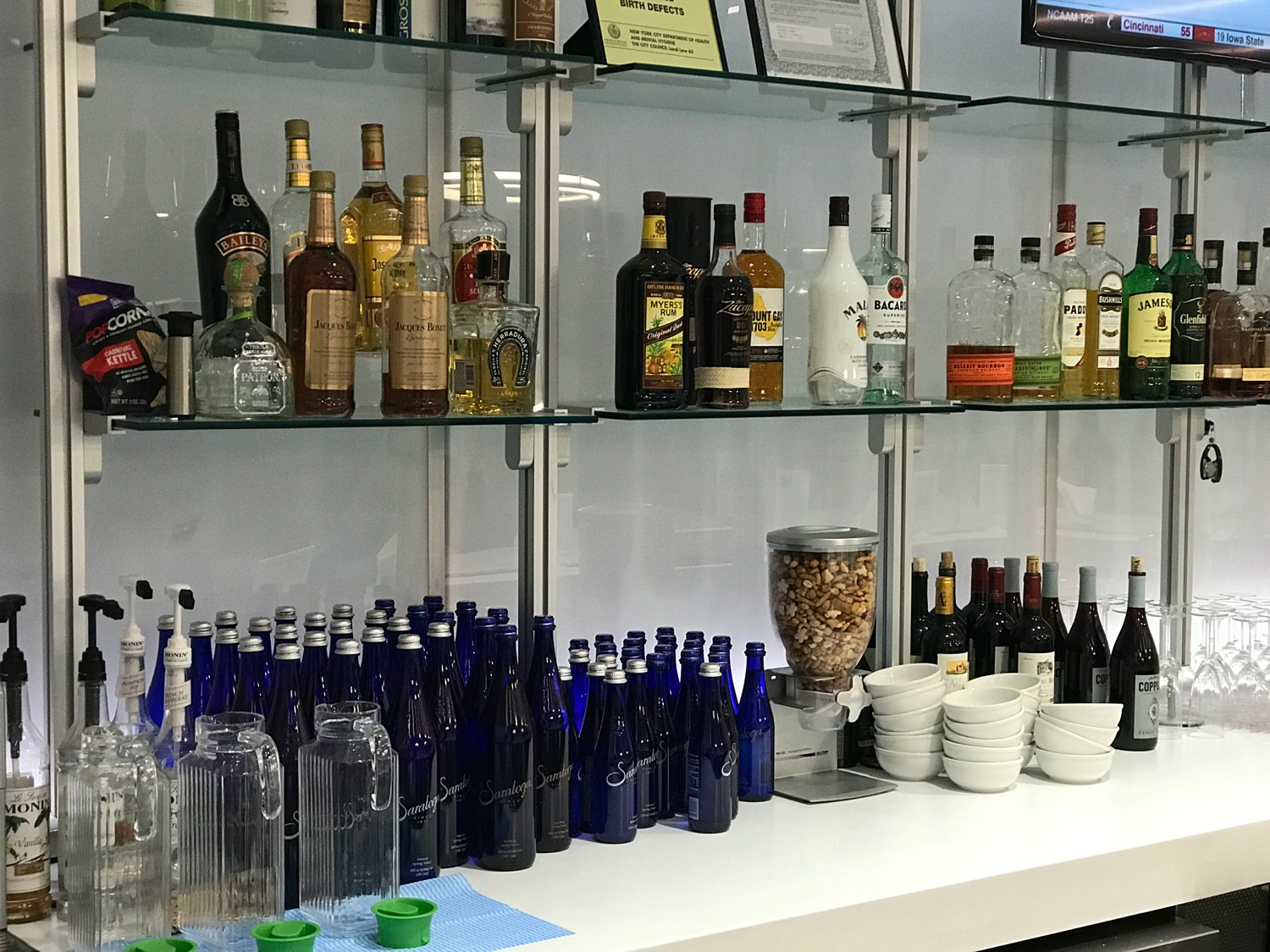a shelf with bottles and glasses