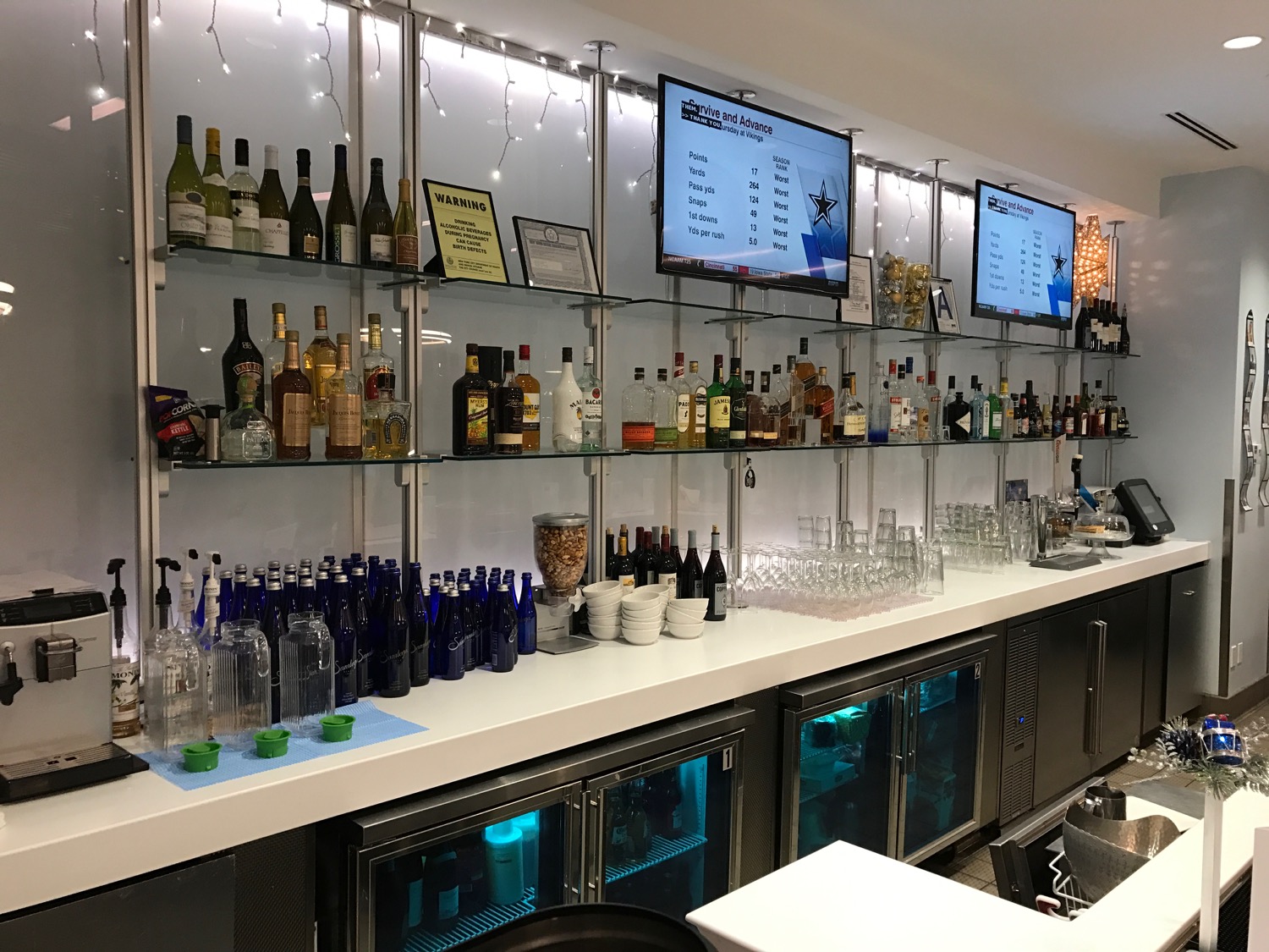 a bar with bottles and glasses on shelves