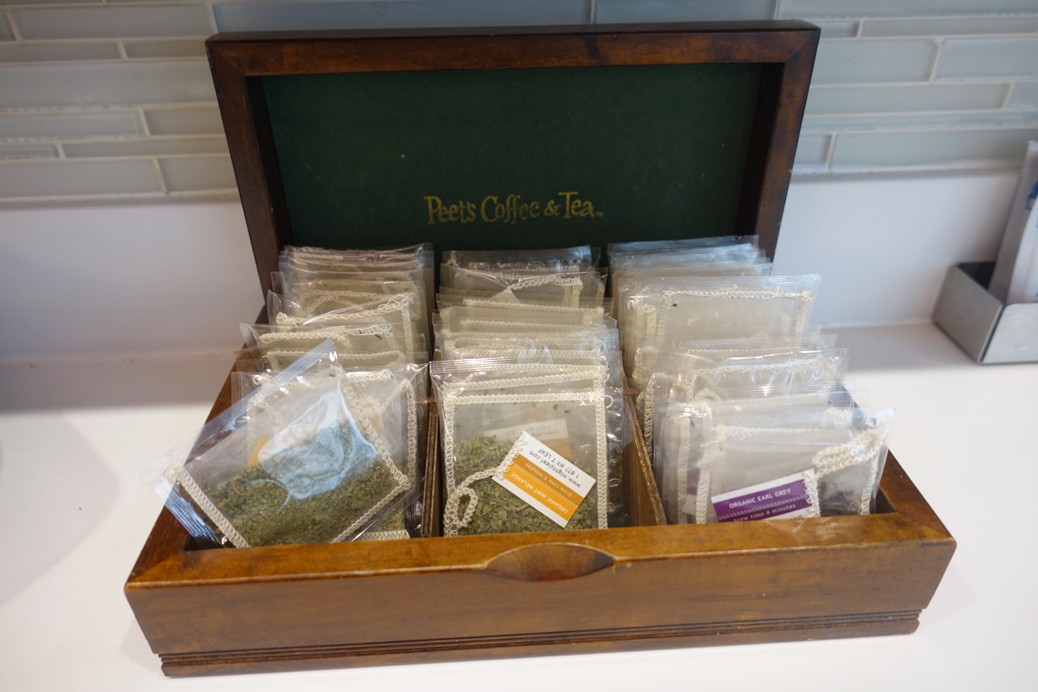 a wooden box with bags of tea