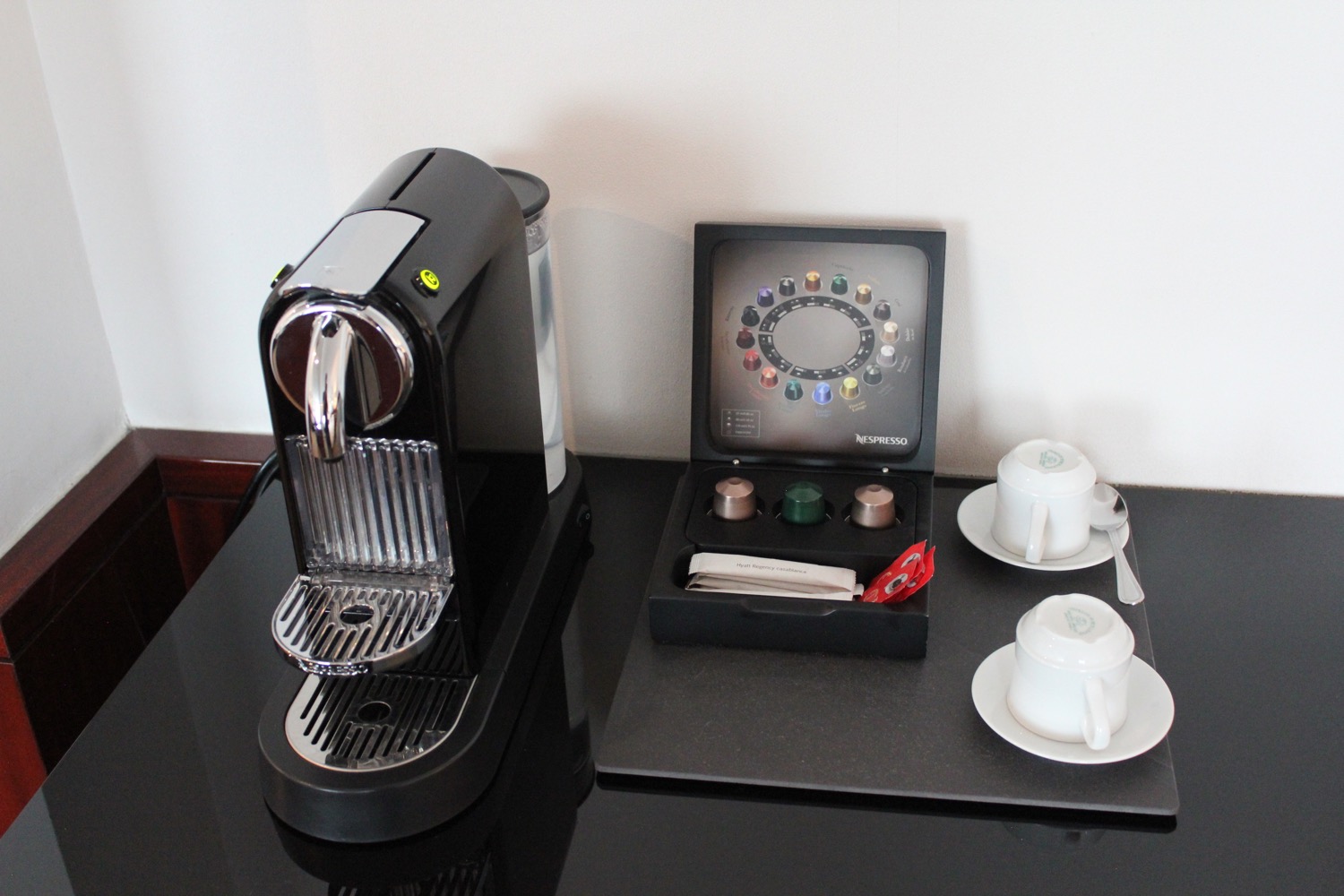 a coffee machine and tea cups on a table