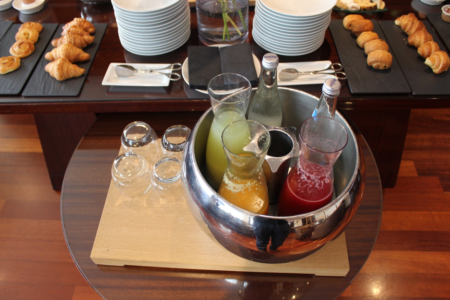 a bowl of juice and glasses on a table