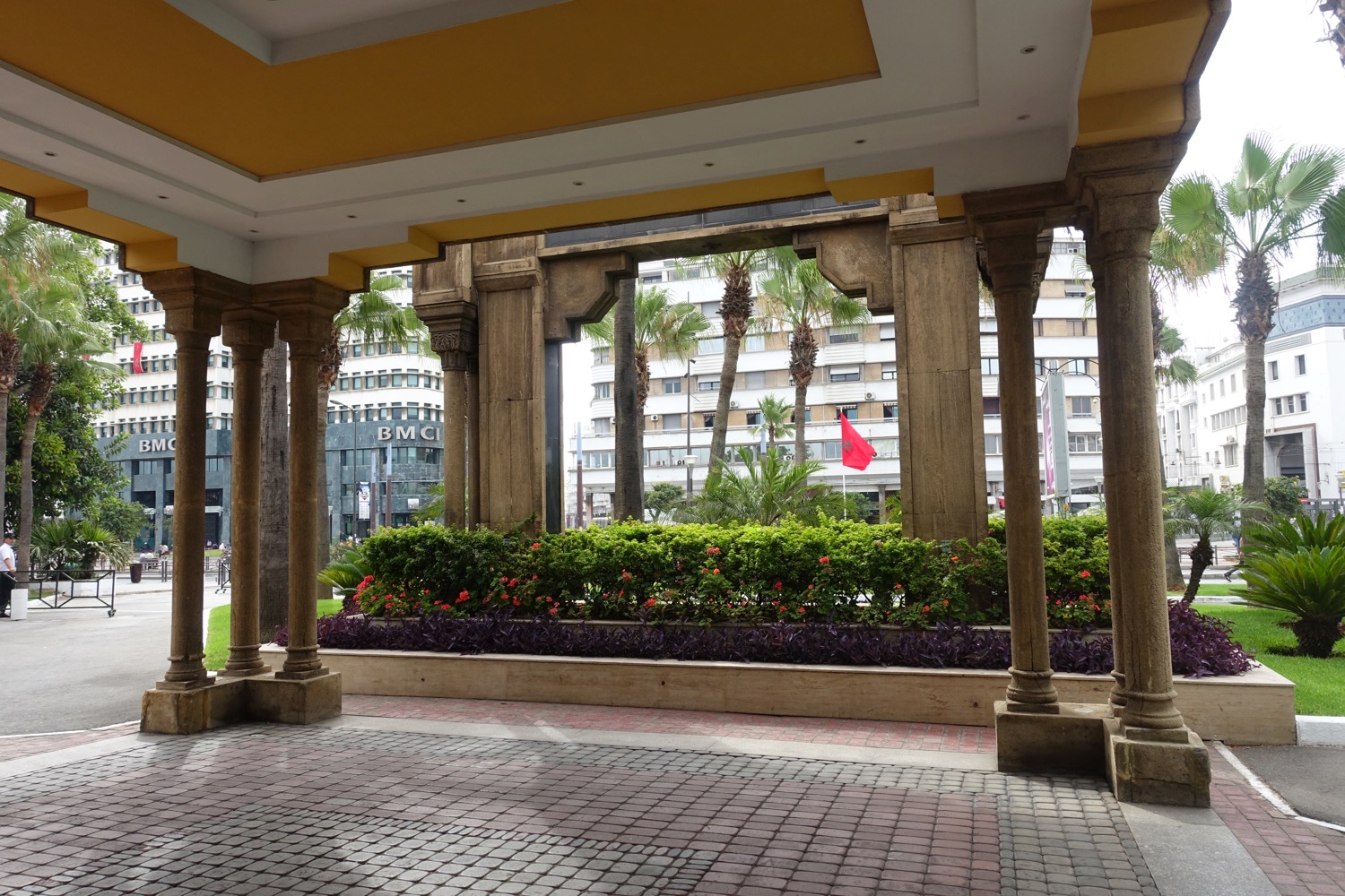 a building with columns and plants