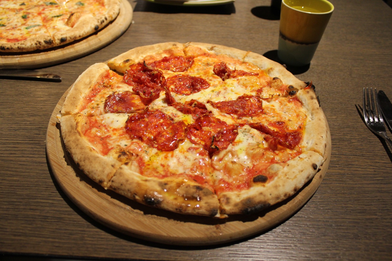 a pizza on a wood plate