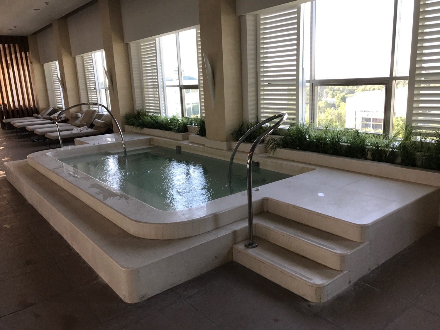 a indoor pool with stairs and plants