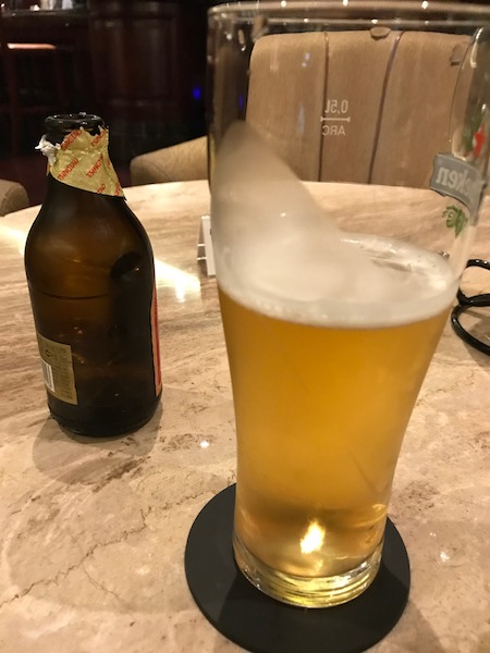 My complimentary beer was served in a glass with the empty bottle, why?