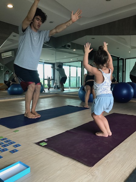 a man and a girl doing yoga