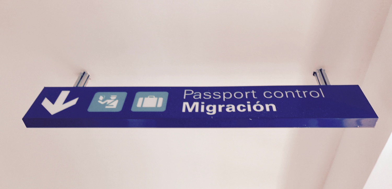 a blue sign with white text and pictograms