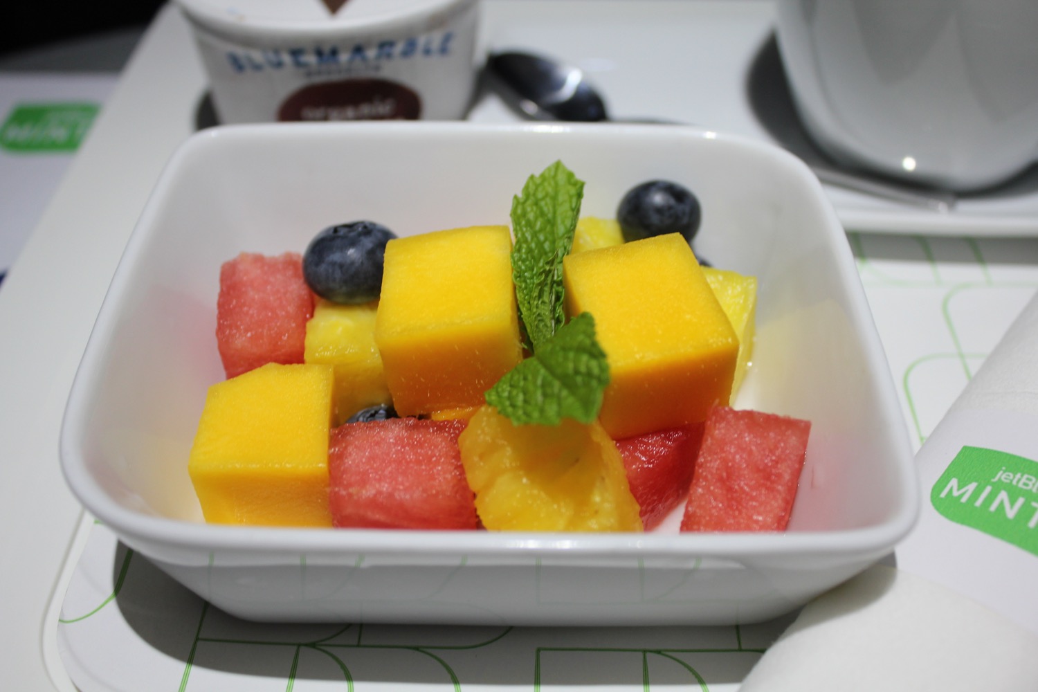 a bowl of fruit with blueberries and watermelon