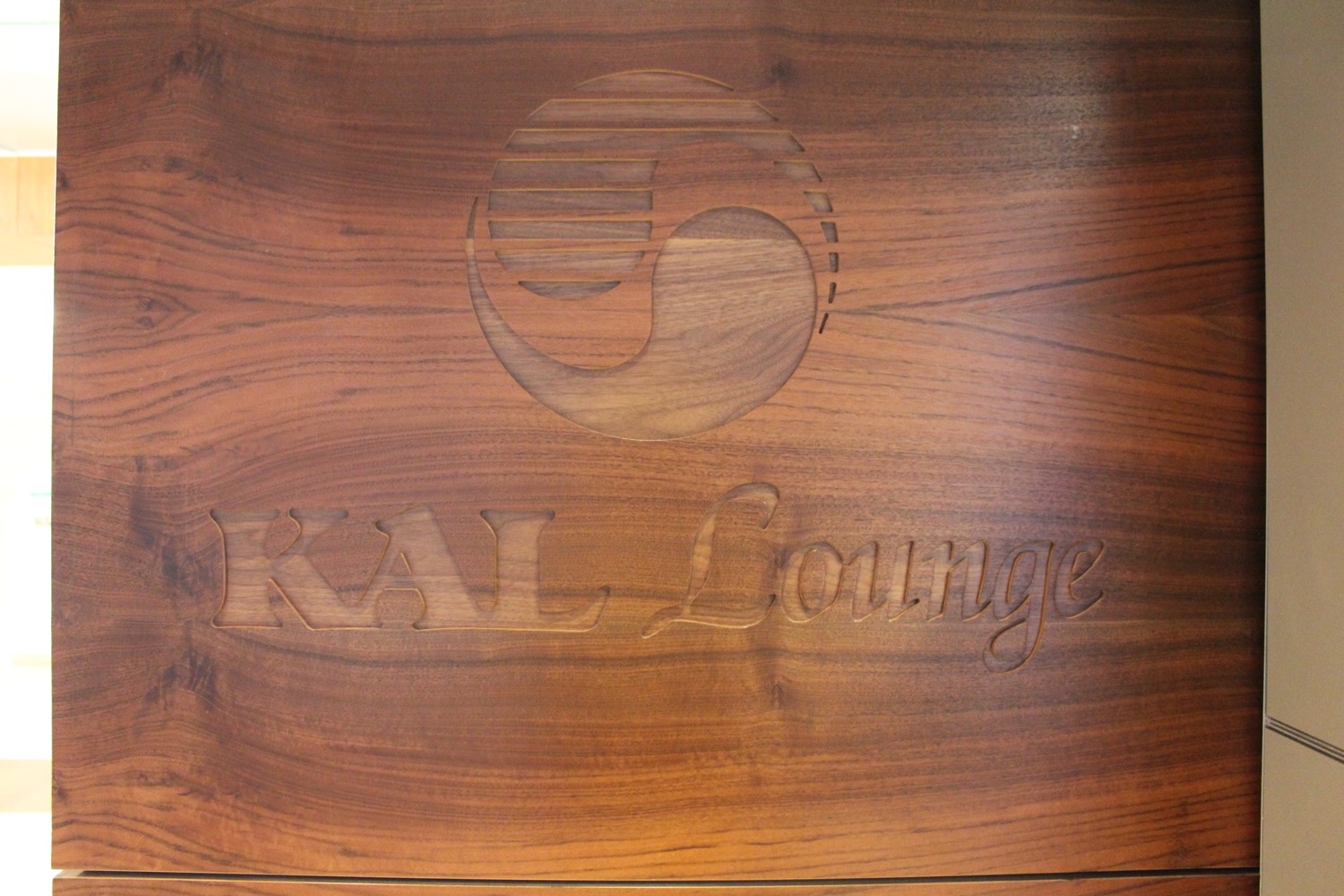 a wood sign with a logo