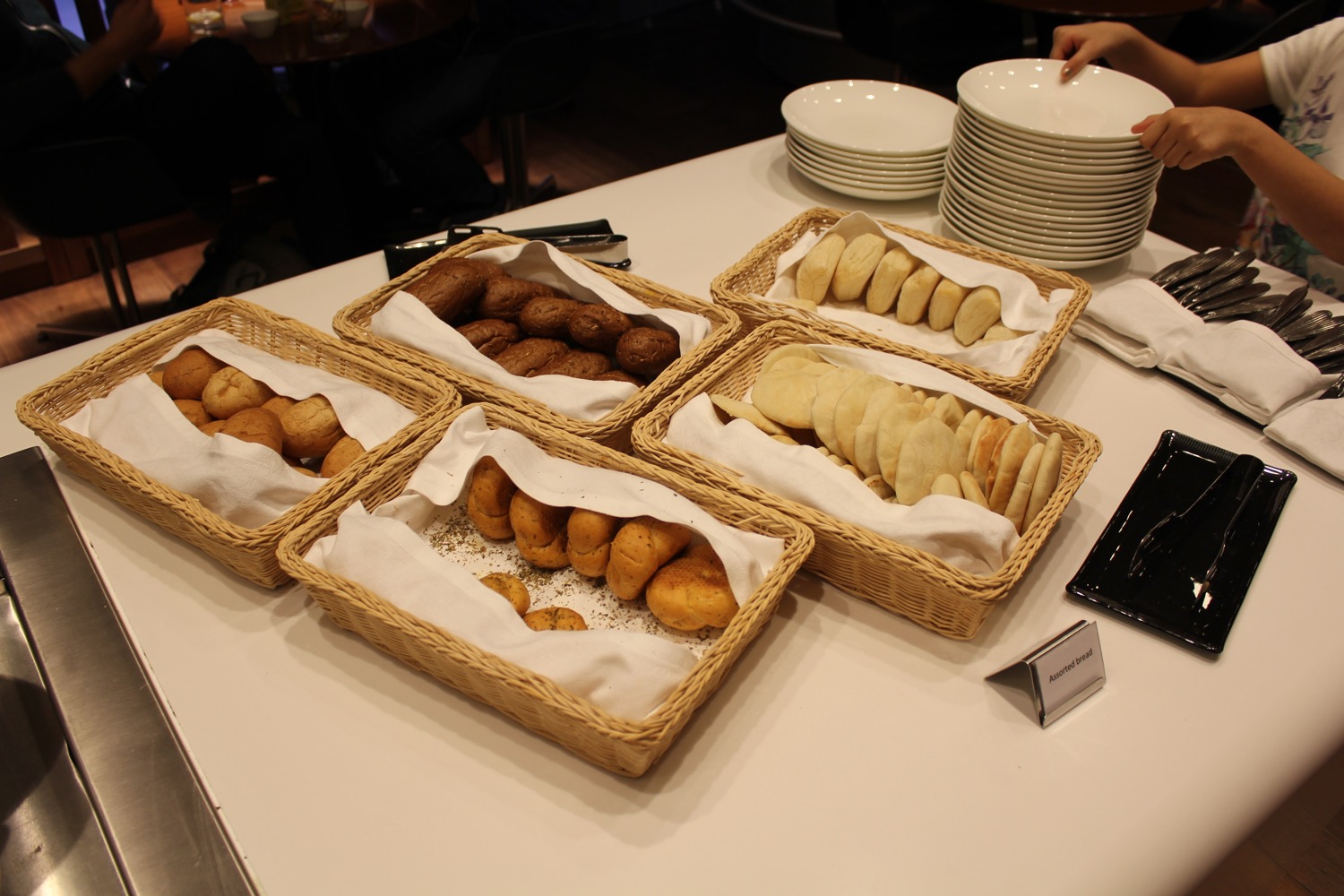 baskets of bread and rolls on a table