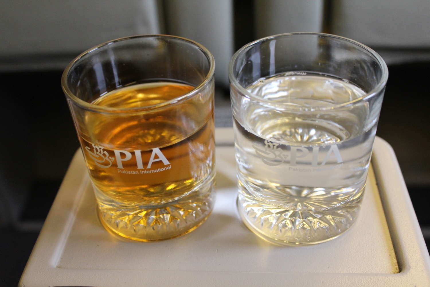 two glasses of liquid on a tray