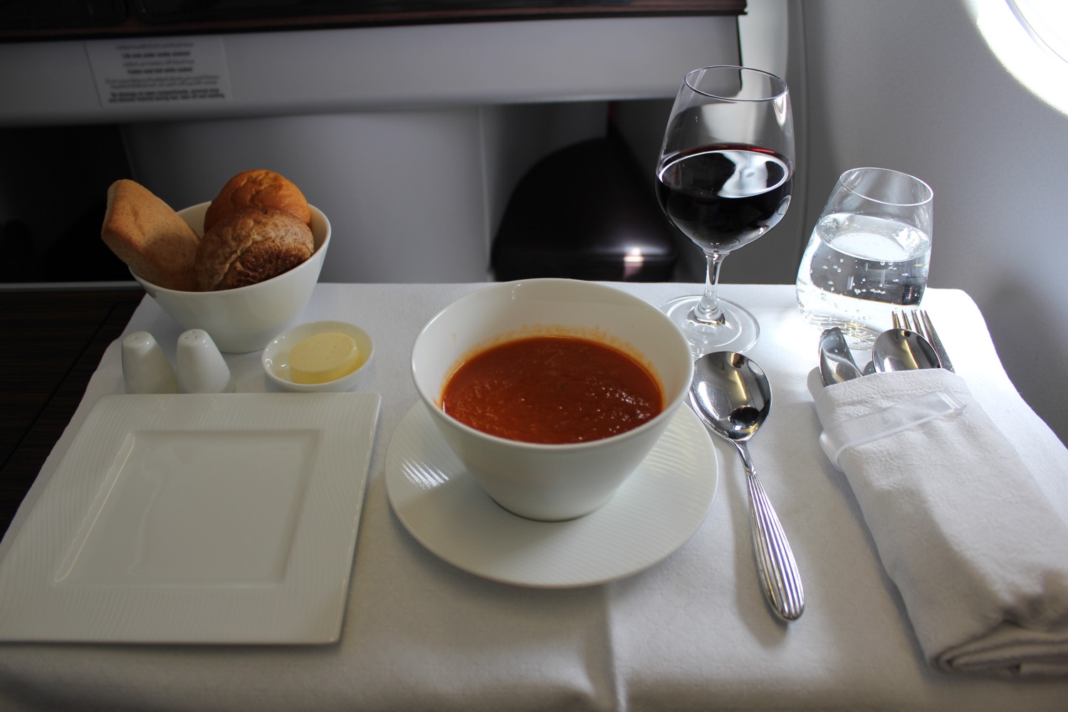 a bowl of soup and a glass of wine
