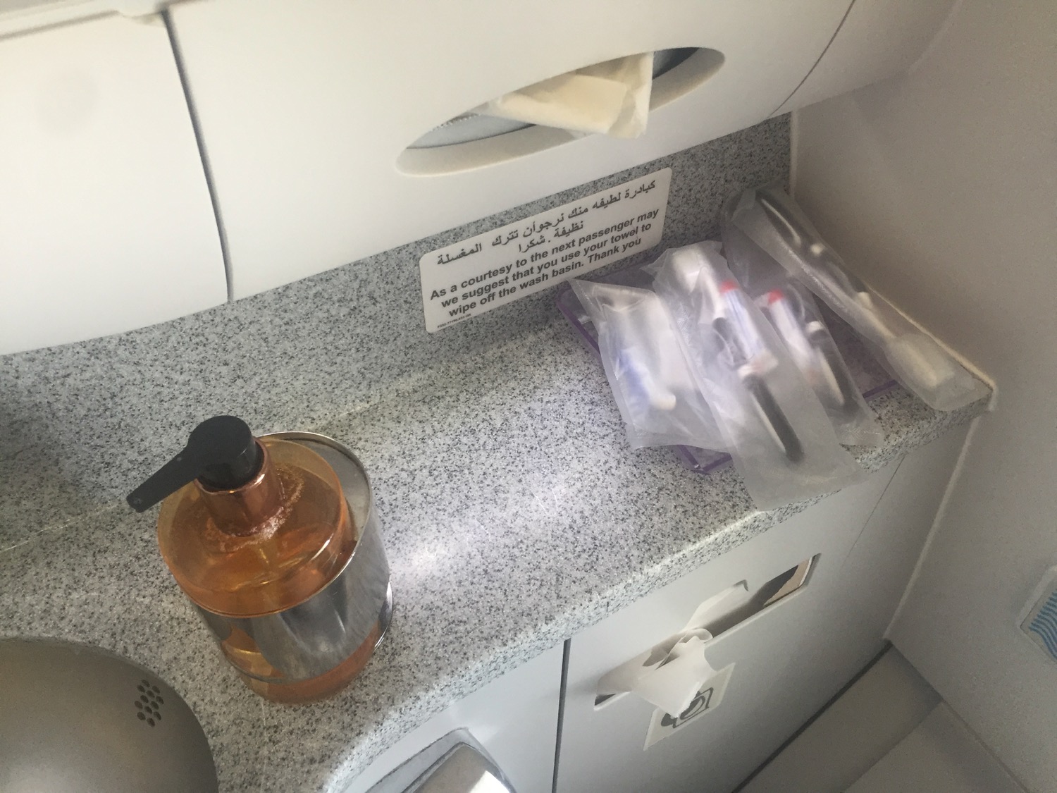 a soap dispenser and other items on a counter