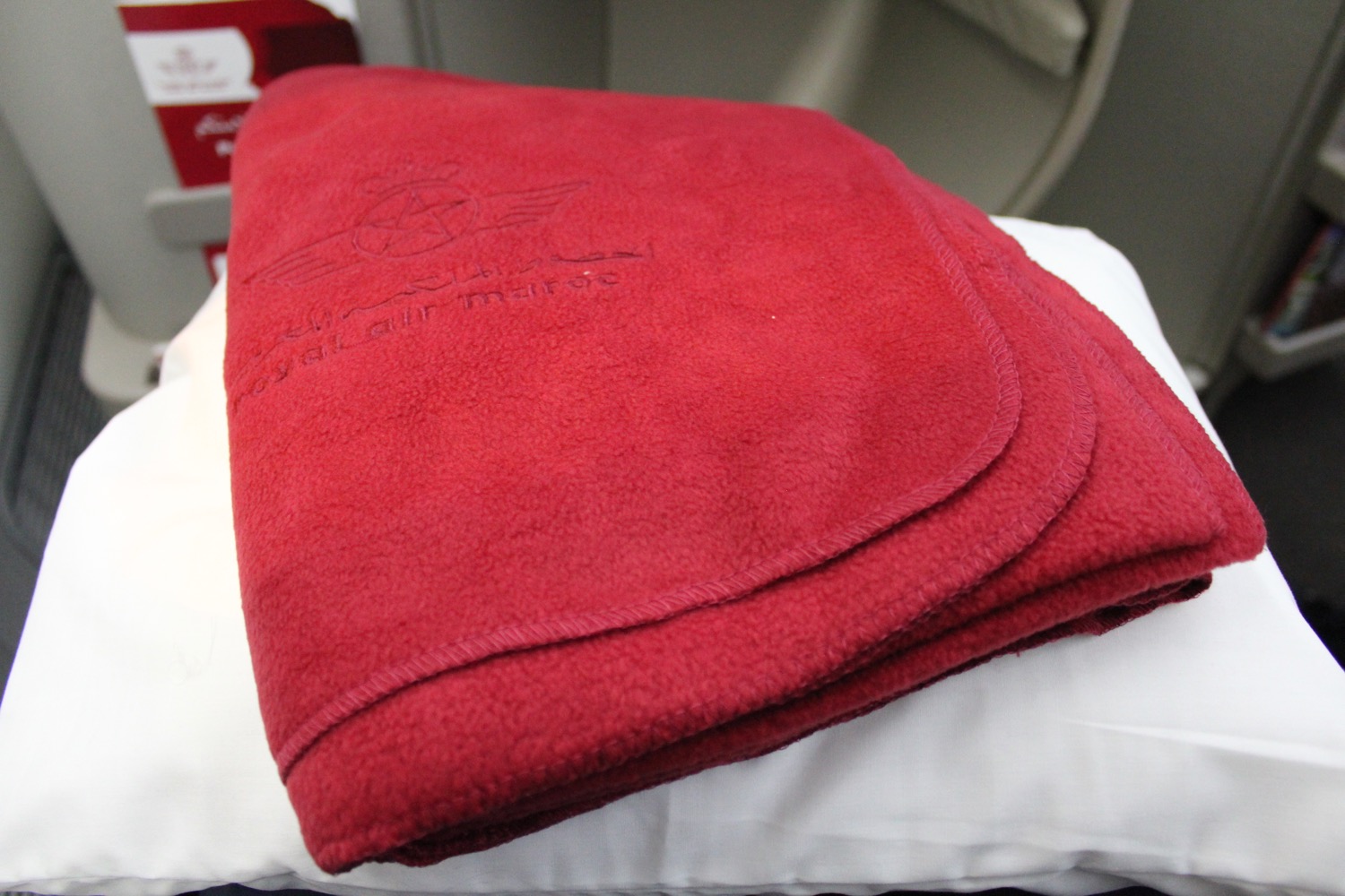 a red blanket on a white surface
