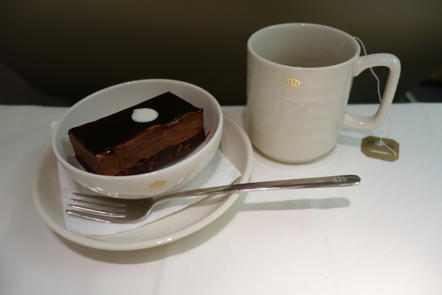 a plate with a piece of cake and a cup of tea