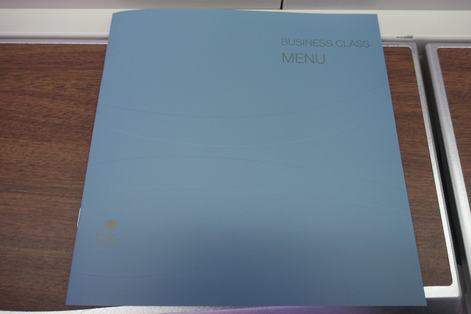 a blue menu on a wood surface