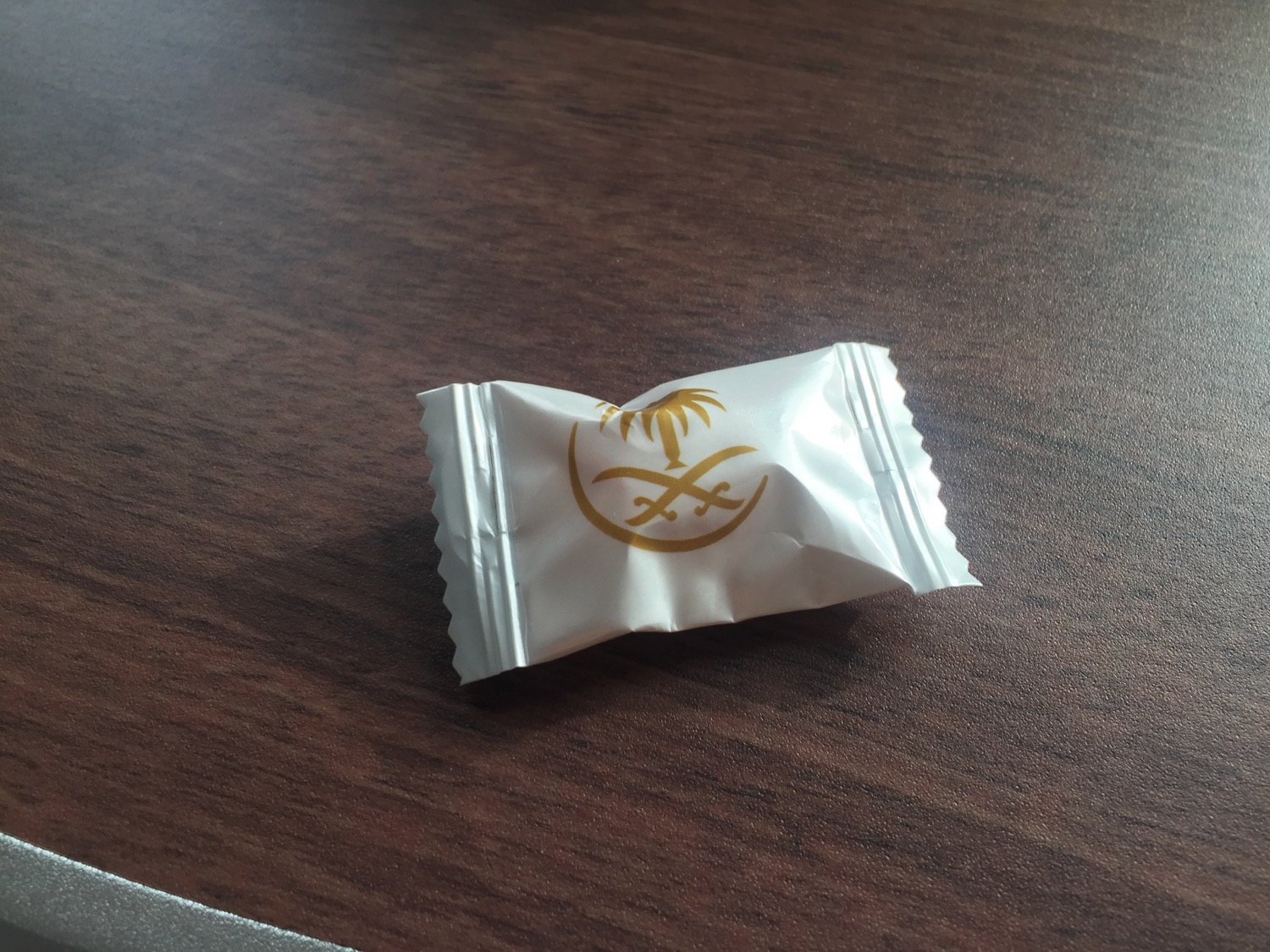 a small white package with gold logo on it