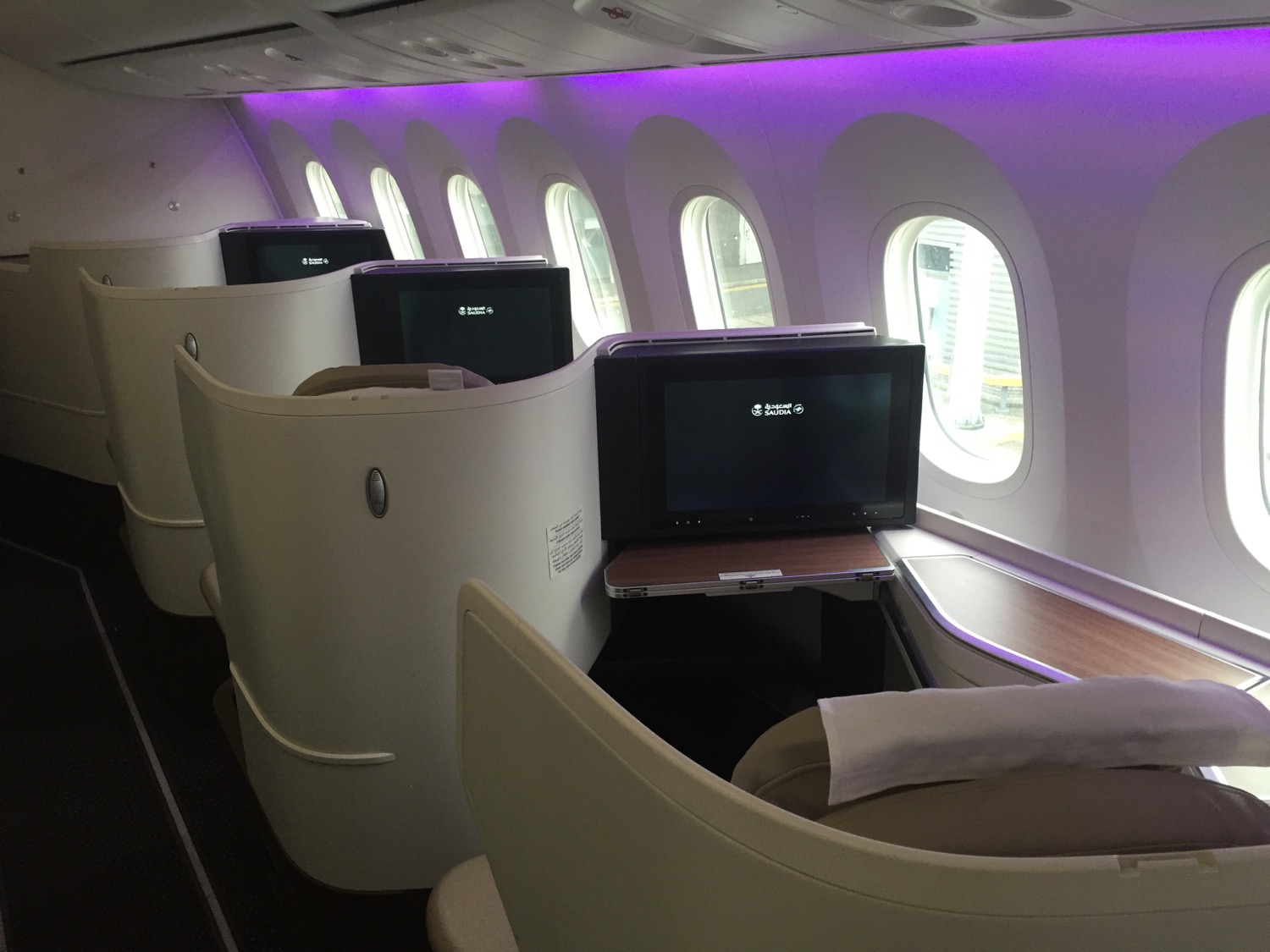 A row of seats with a TV on the side