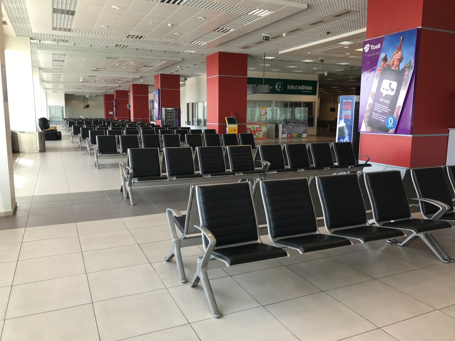 a row of black chairs in a terminal