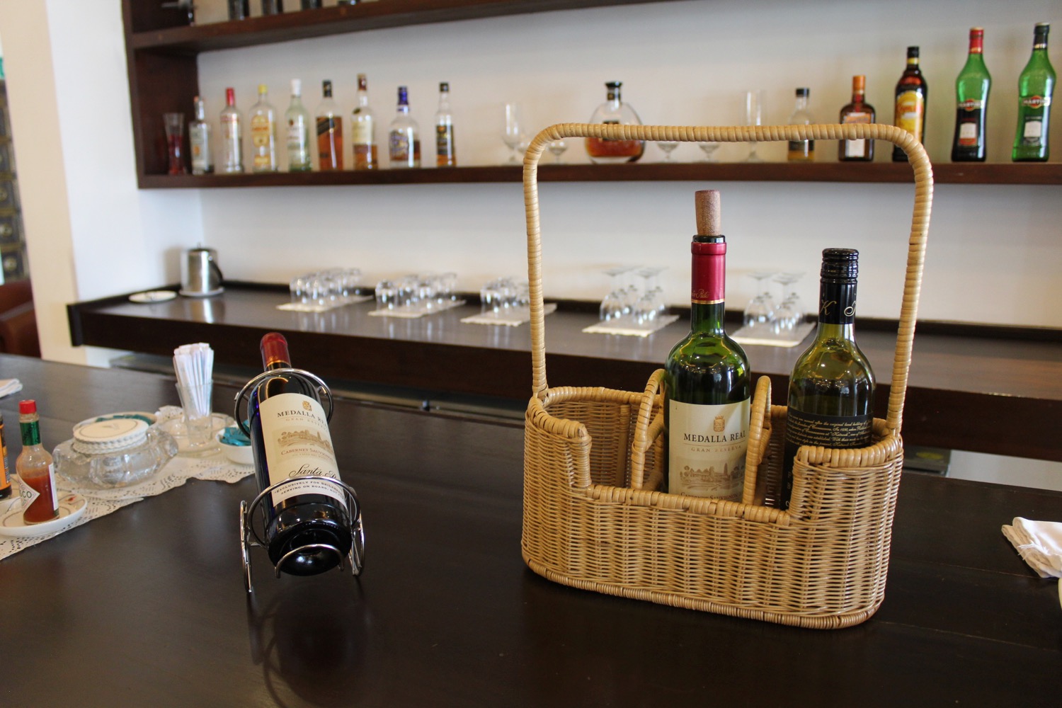 bottles of wine in a basket on a table