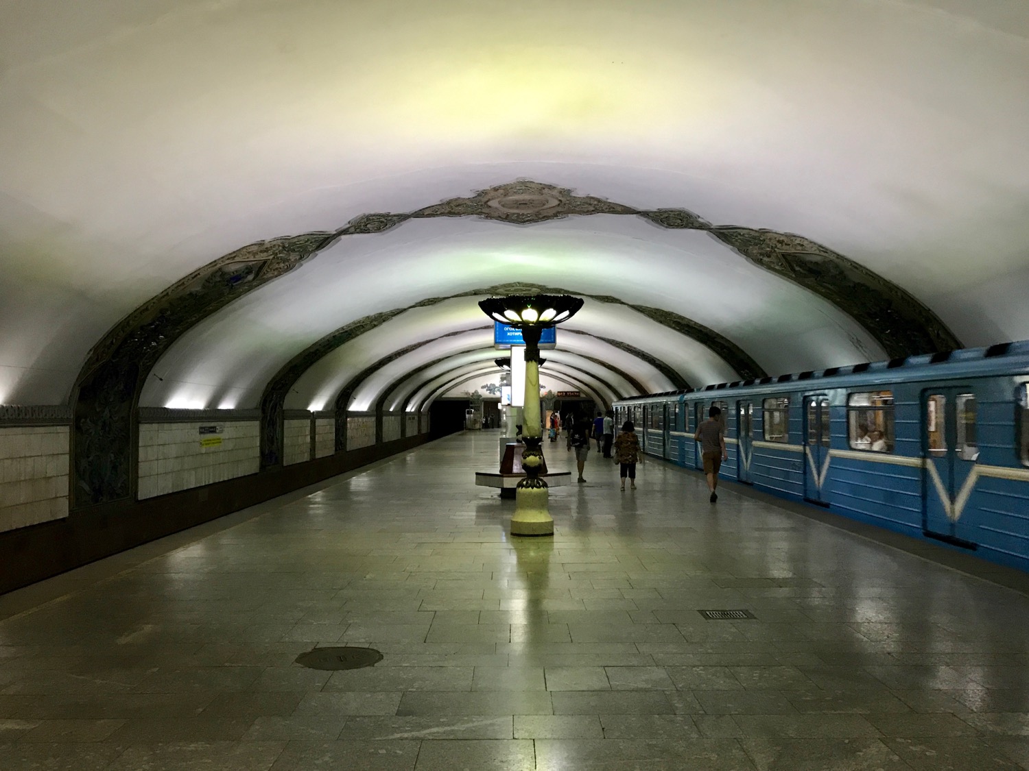 a subway station with a blue train