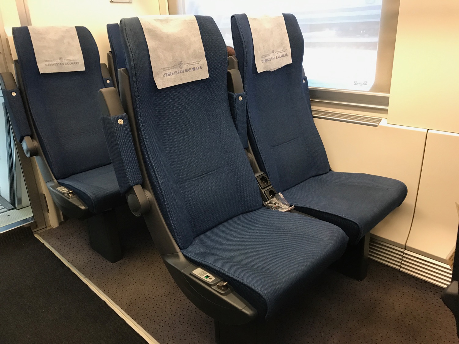 a row of blue seats with white towels on them