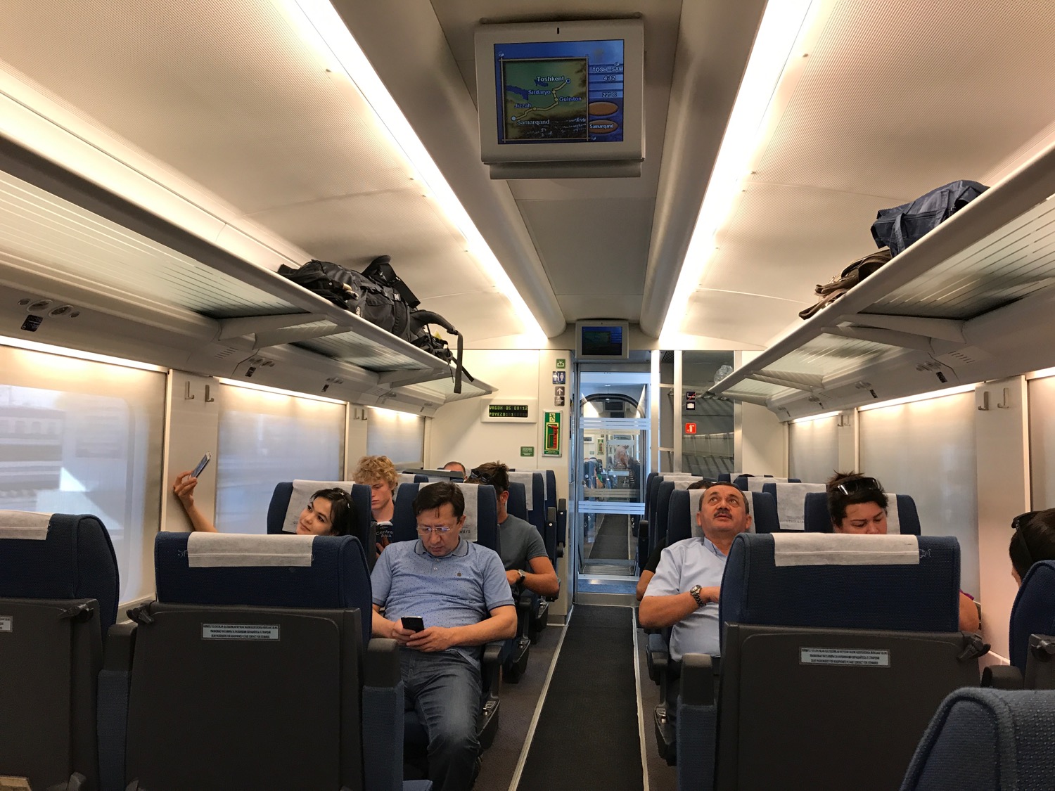 a group of people sitting in a train