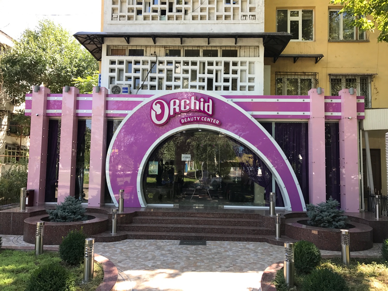 a purple and white building with a pink arch