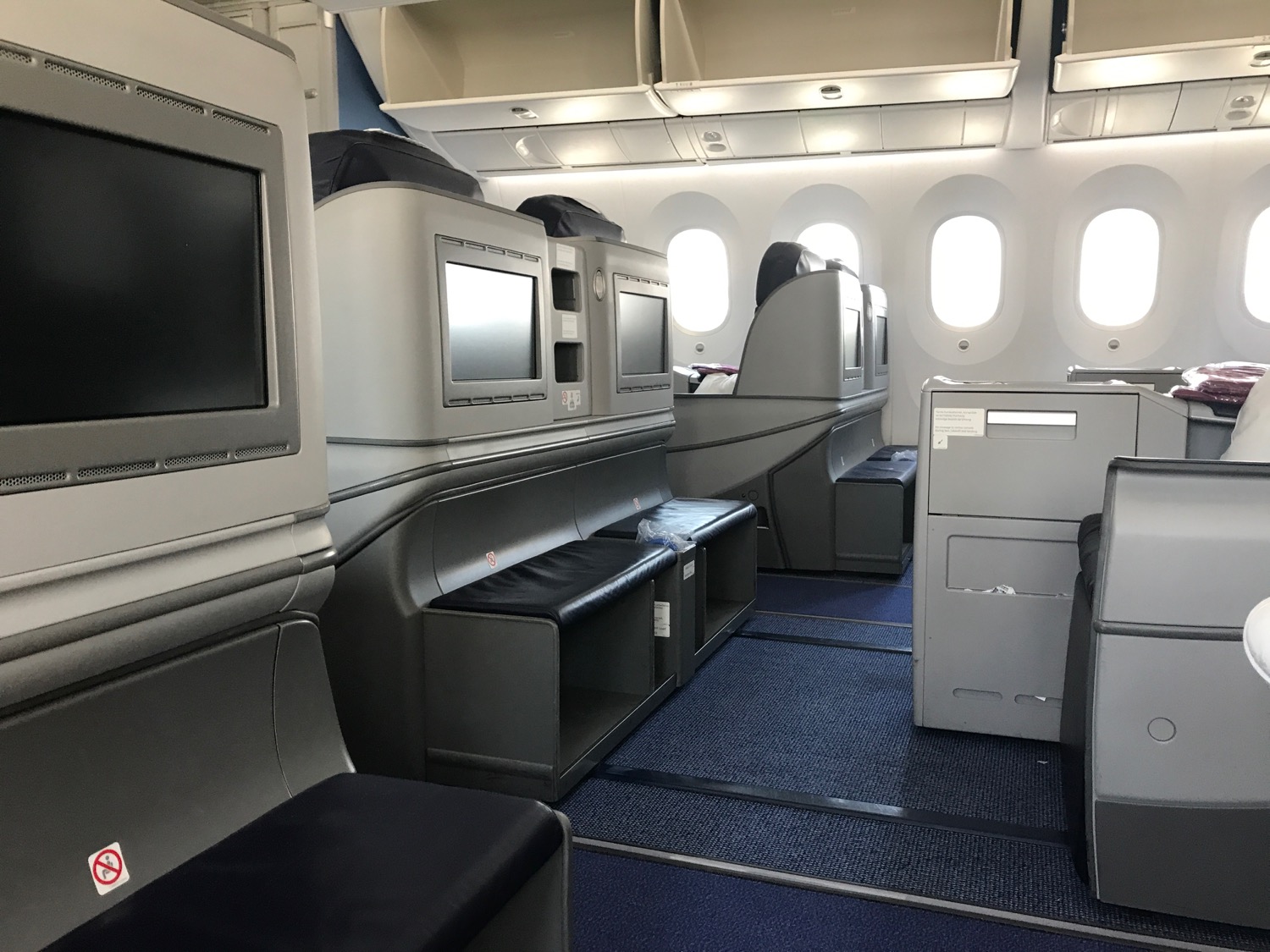 a row of tvs in an airplane