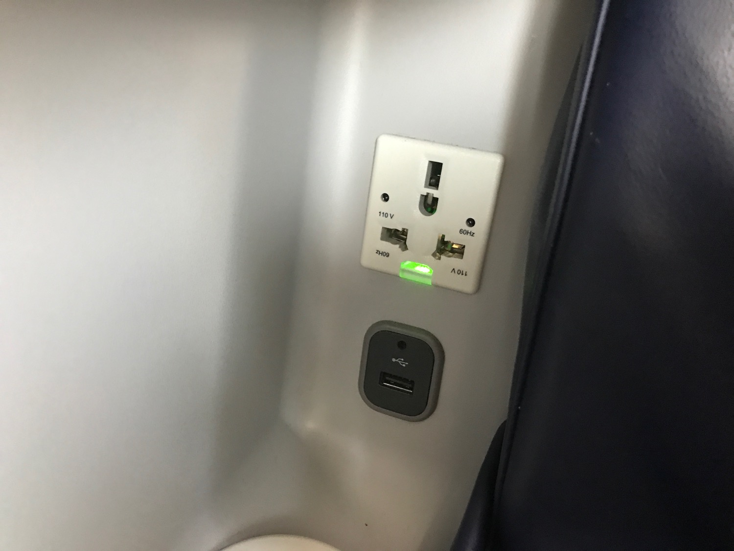 a wall outlet with a green light