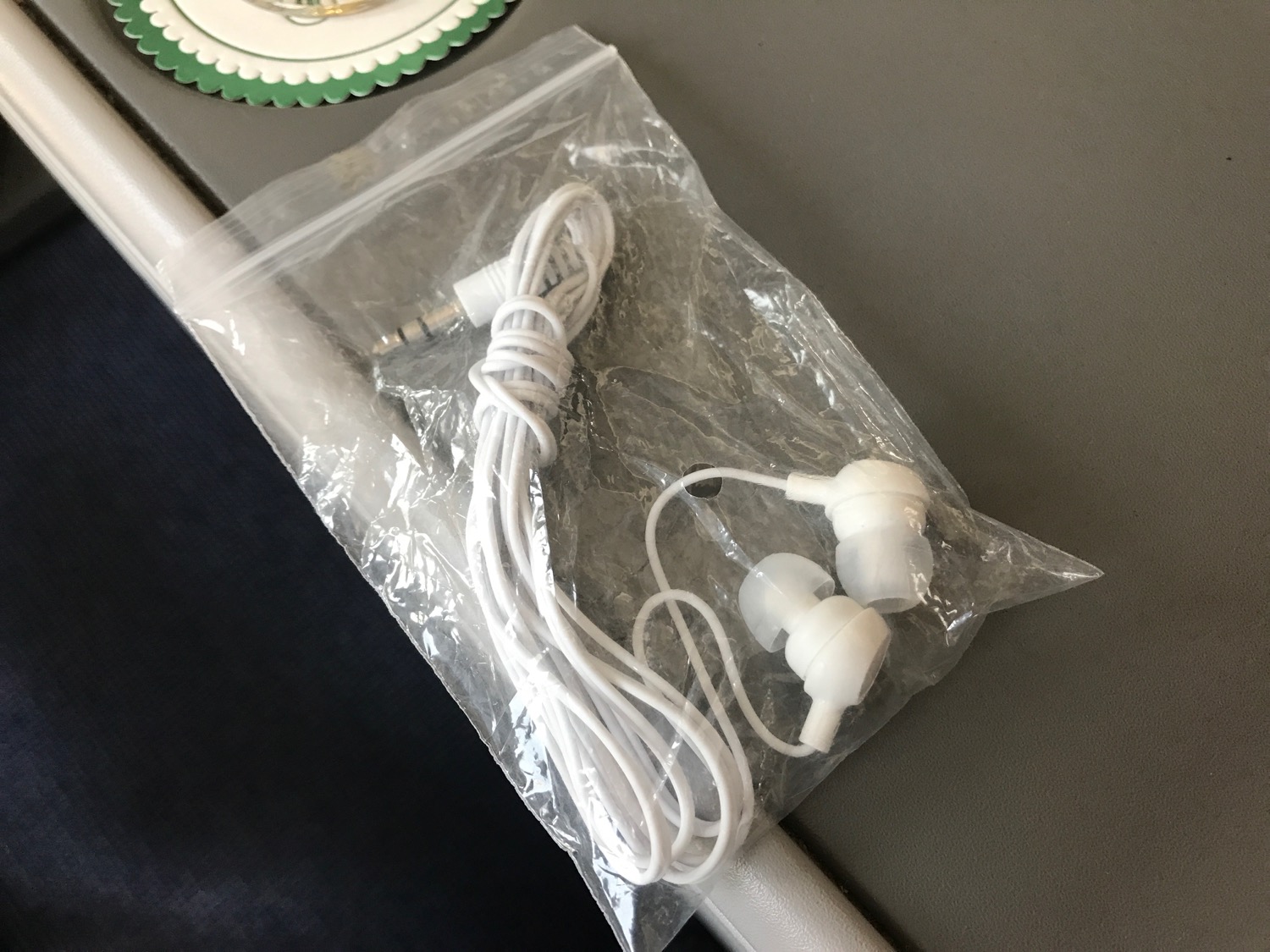 a white earbuds in a plastic bag