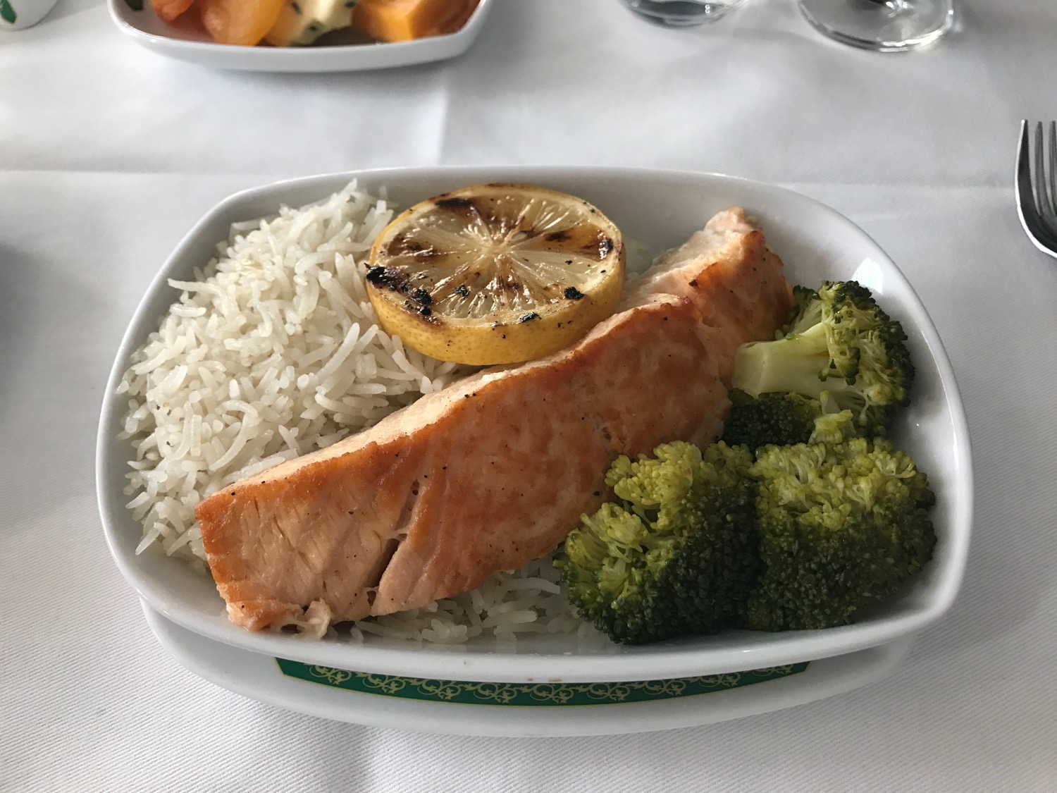 a plate of food with a lemon slice and rice