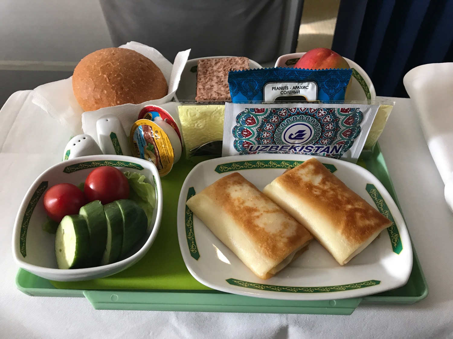 a tray with food and a bowl of vegetables