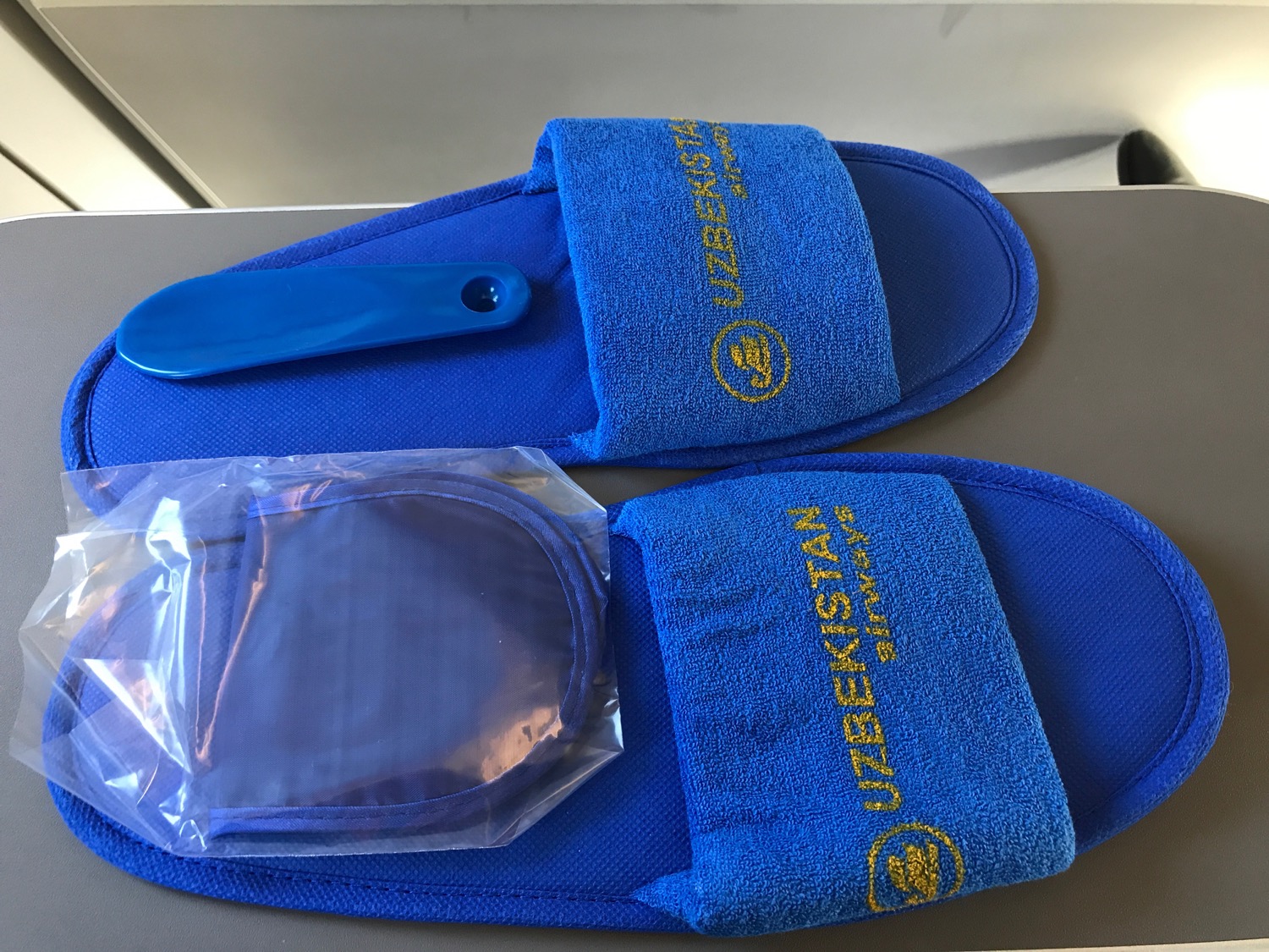 a pair of blue slippers with a blue handle