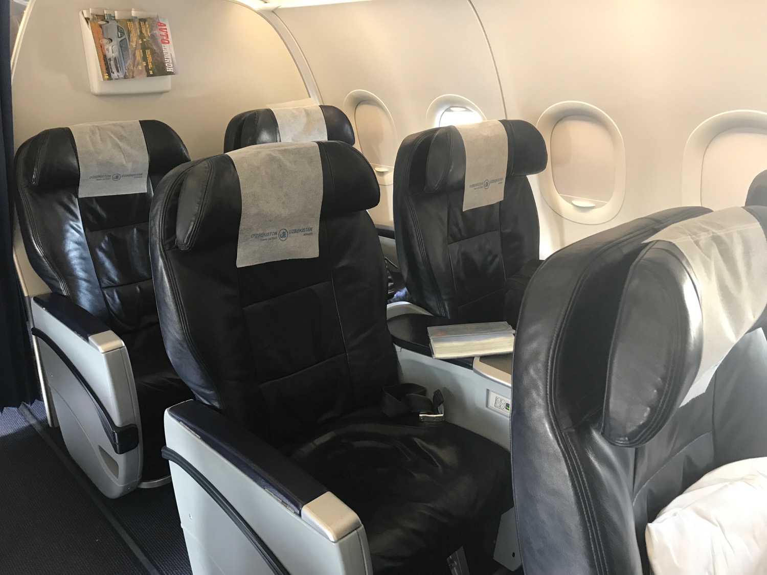 a row of black seats on an airplane