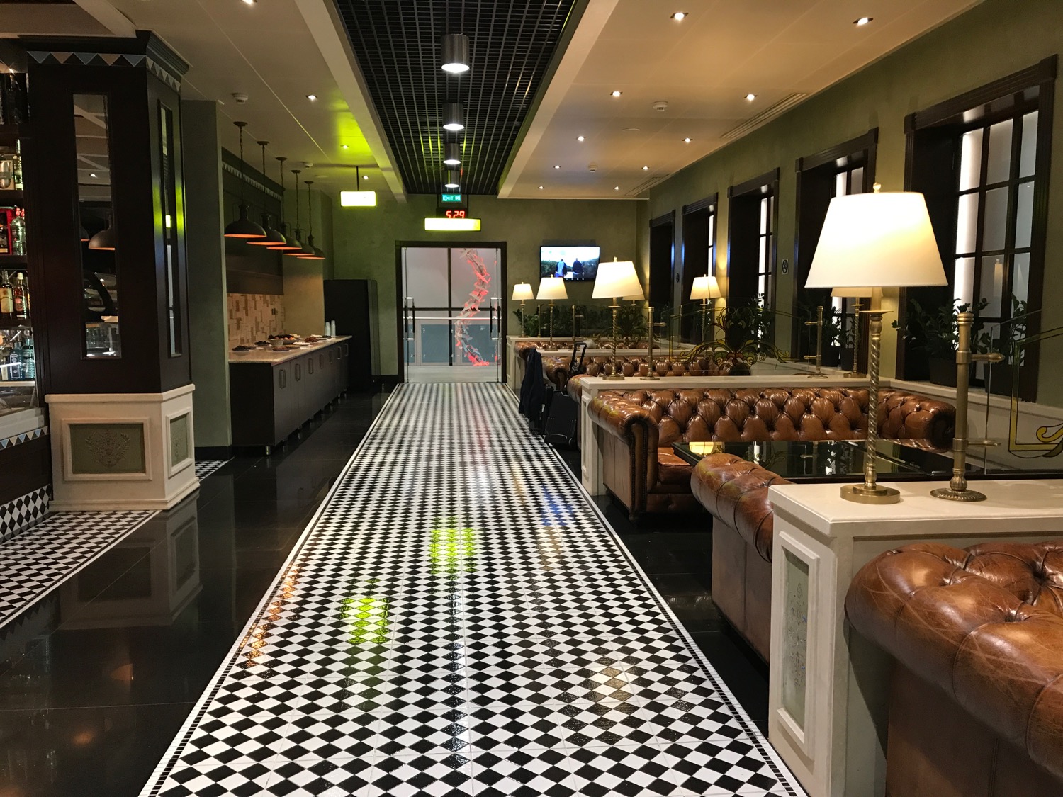 a black and white checkered floor with leather couches and a black and white checkered floor