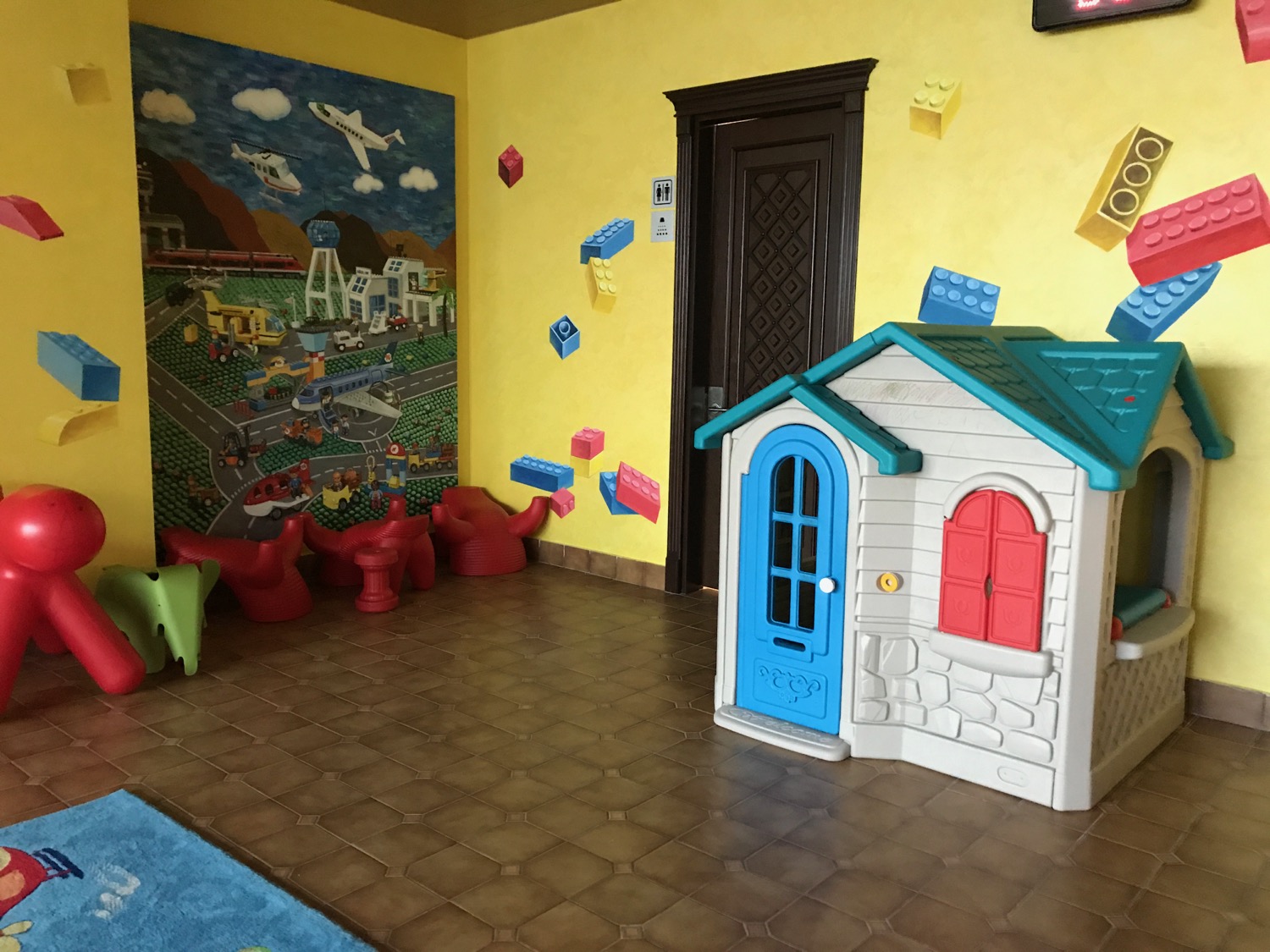 a toy house in a playroom