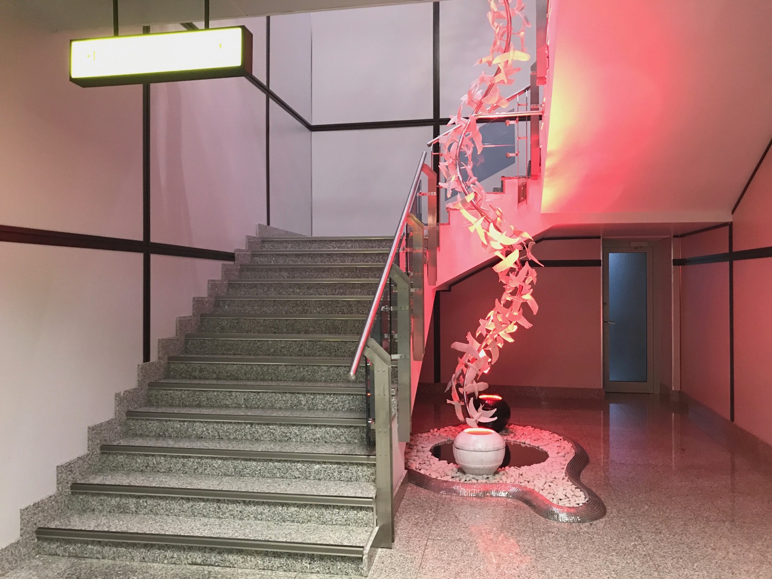 a staircase with a plant on the ground