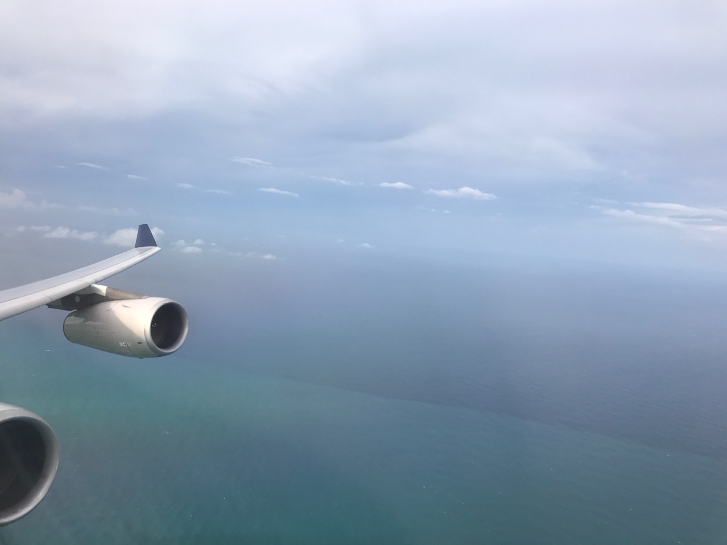 an airplane flying over the ocean