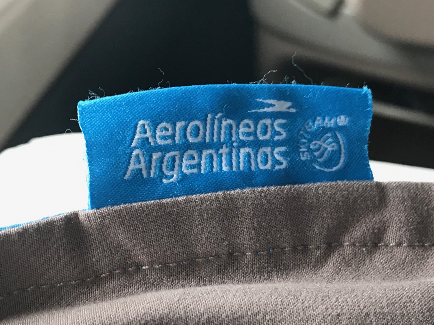 a blue label on a brown shirt