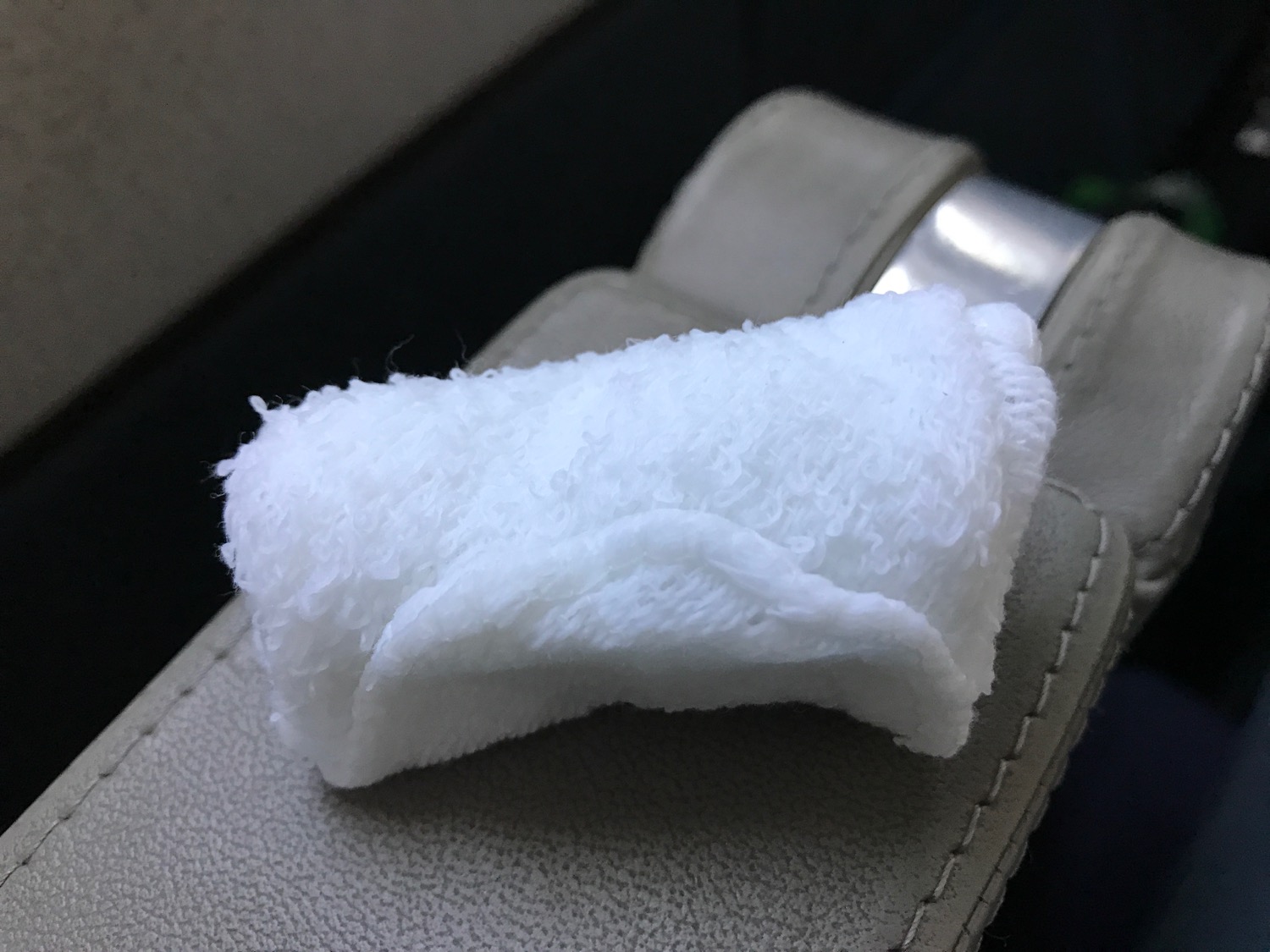 a white towel on a leather strap