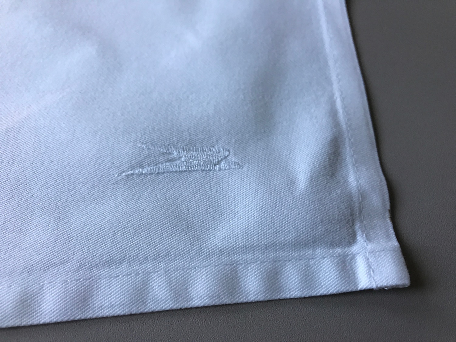 a white cloth with a logo on it