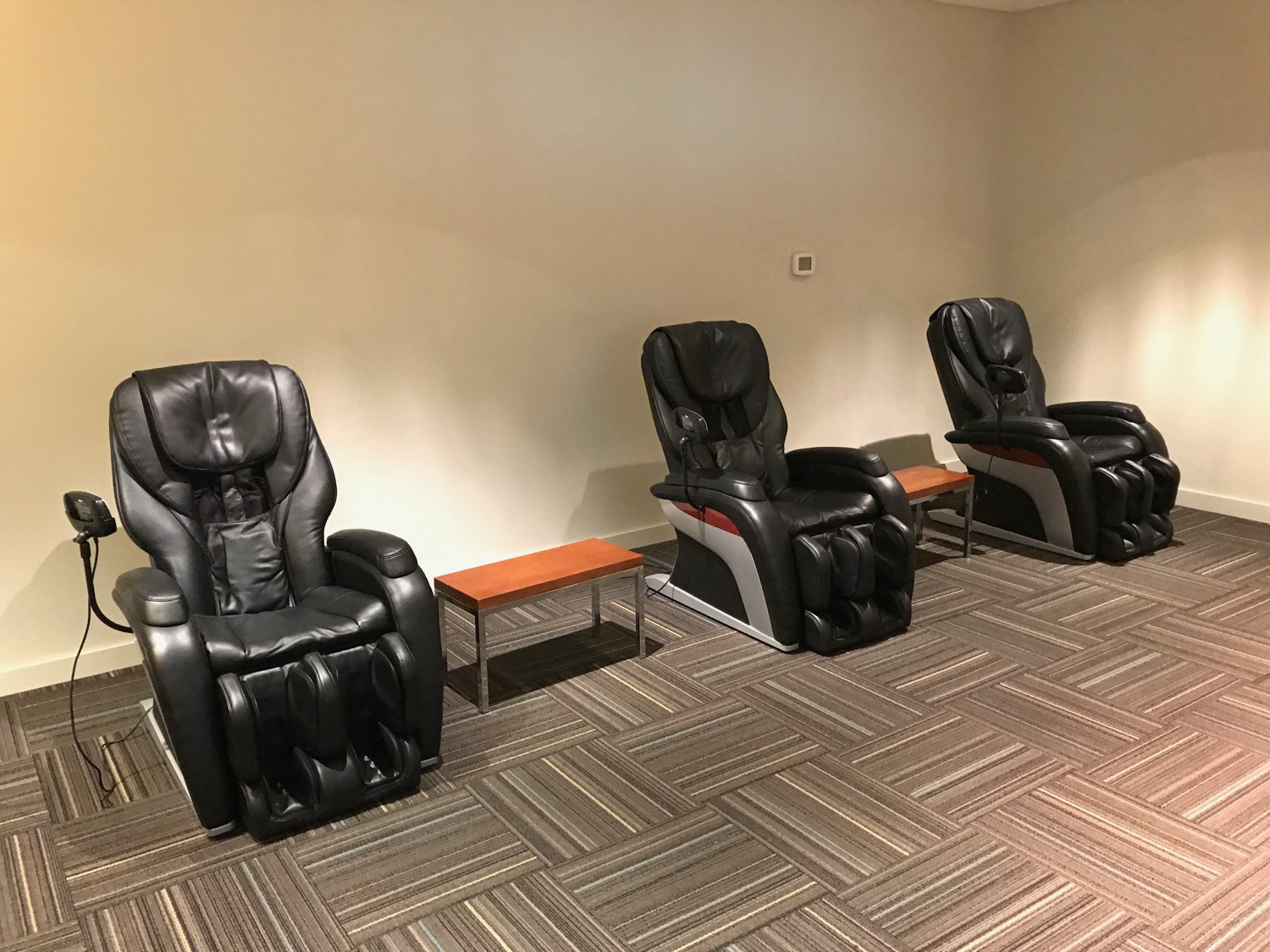 a group of black recliner chairs in a room