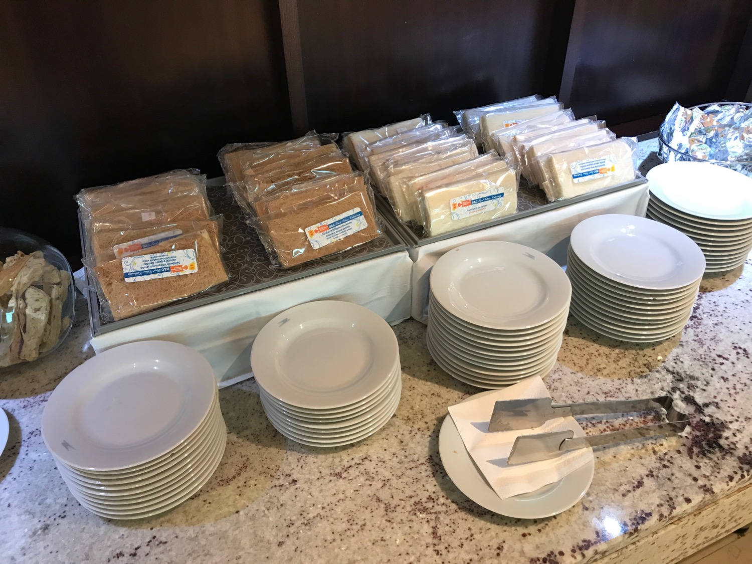 a stack of plates and a tray of food