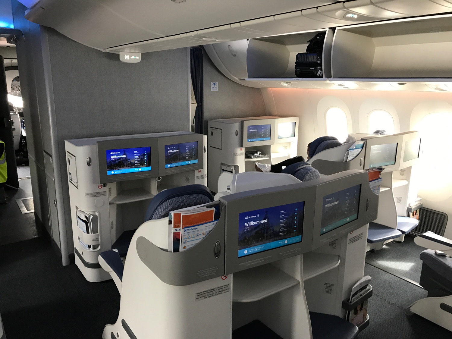 a seats and monitors in an airplane